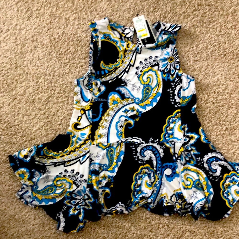 Brand new sleeveless shirt. It was purchased at Stein Mart. It is medium.